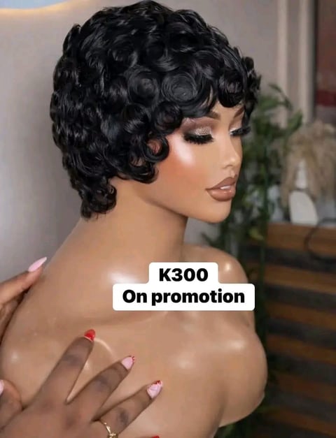 Black curly short wig on display mannequin with K300 promotion text, manicured nails visible