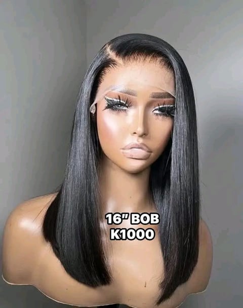 Mannequin head displaying a 16 inch black Bob K1000 wig with long straight hair and styled makeup